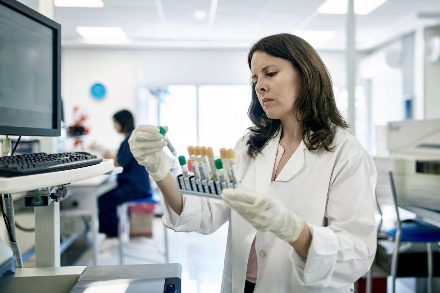 Lab scientist examining blood test samples in a NATA-accredited laboratory